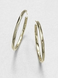 From the Glamazon Collection. Simple, sculptural hoops in subtly faceted gold are both modern and timeless.18k yellow goldDiameter, about 1.6Post backImported