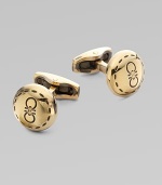 Round brass design engraved with iconic double gancini details, in a unique goldtone.BrassAbout ½ diam.Made in Italy