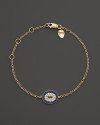 Sapphire and white diamonds add sparkle to a 14K. yellow gold evil eye bracelet by Meira T.