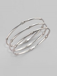 From the Bamboo Collection. Slim and elegant in fine sterling silver, this set of three bangles displays the graceful pattern of bamboo. This design was expressly created to support an afforestation project on Nusa Penida, an arid island off the coast of Bali. For every purchase, John Hardy will donate a portion of the retail price to the cost of planting bamboo. This bangle set helped plant 6 bamboo seedlings. Sterling silver Diameter, about 2½ Set of 3 Made in Bali