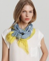 A chic oblong scarf featuring a falling square print and bright yellow background.