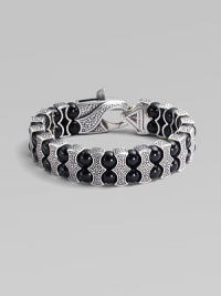 Architectural drama defines this bold bracelet, constructed of double rows of black onyx beads held by scalloped pillars of sterling silver. Black onyx Sterling silver Length, about 8¾ Lobster clasp Imported