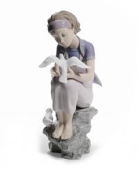 Experience tranquility. Perched on a rock embracing the simple joys in life, a graceful young lady studies the beauty and purity of visiting doves. A peaceful reminder to slow down and study the brilliant details in life, by Lladro.