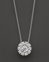 White gold diamond flower cluster pendant. With signature ruby accent. Designed by Roberto Coin.