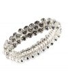 An elegant finishing touch from Anne Klein. Glass and plastic stones in clear hues lend a look of sophistication to this bracelet. Crafted in silver tone mixed metal. Approximate diameter: 2 inches. Stretches to fit wrist.