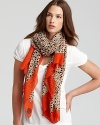 Wild yet mild, this stylish Tory Burch scarf mixes a subdued cheetah print with a bold red border.