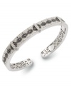 A style refresh. Stunning round-cut white diamonds (3/10 ct. t.w.) and black diamonds (1/10 ct. t.w.) form a sophisticated pattern on this sparkling bangle. Set in sterling silver. Approximate diameter: 3-1/2 inches.