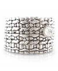 Simple style in head-turning silver. Jessica Simpson's unique cuff bracelet features a textured surface in silver tone mixed metal. Bracelet stretches to fit wrist. Approximate diameter: 2-1/4 inches.