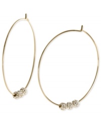 Michael Kors adds an elegant touch to its pair of hoop earrings. Crafted from gold ion-plated mixed metal, the earrings feature glass pave fireballs for a lustrous touch. Approximate diameter: 2 inches.