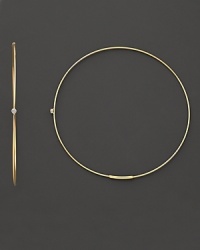 Single diamonds wink from the center of these delicate 14K gold hoops.