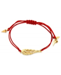 Let your look take flight. This RACHEL Rachel Roy bracelet showcases a wing charm with glass stone accents. An adjustable red waxed cotton cord holds it all together. Set in worn gold tone mixed metal. Approximate diameter: 1 inch. Adjustable from 1 inch to 7-1/4 inches.