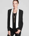 A sharp asymmetric hemline is eye-catching on this Rebecca Minkoff silk blazer, replete with puff shoulders and pleating at the elbows. In line with the season's color block trend, the graphic look updates the LBD from subtle to sublime.