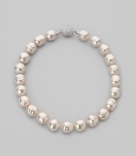 A dramatic yet simple strand of white baroque pearls, with a sparkling clasp of cubic zirconia. 16mm white man-made organic pearls Length, about 17 Sterling silver and cubic zirconia ball clasp Made in Spain