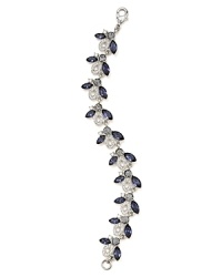 This Carolee bracelet styles your look with effortless elegance, set in silver tone plate and accented by clusters of colored crystal stones.