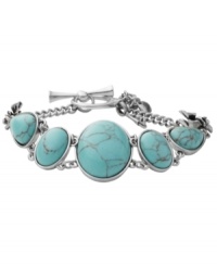 Breezy, bohemian style. Perfect for the free spirit, Fossil's trendy toggle bracelet includes reconstituted turquoise stones set in vintage silver tone mixed metal bezels with orchid details. Approximate length: 8 inches.