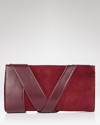 Z Spoke Zac Posen makes a mixed media statement with this suede and leather clutch. Ideally sized for day-to-night, this piece is texture rich with bold leather bands.