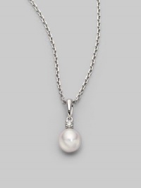 Simple and lovely, a white, round cultured Akoya pearl has a sparkling diamond accent, plus a chain and setting of 18k gold. 7mm white round cultured pearl Quality: A+ Diamond, 0.05 tcw 18k white gold Length, about 18 Spring ring clasp Imported