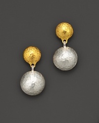 A double drop earring from Gurhan, designed with hammered 24 Kt. yellow gold and white silver discs.