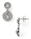 Pave-set crystals frame faceted cubic zirconia stones on these rhodium-plated earrings from Nadri. Wear this pair to take evening looks from simple to stunning.