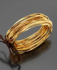 Bask in the beauty of stylish, jingling bangles. This set of twenty goldtone bangle bracelets is crafted in shining goldtone mixed metal. Approximate diameter: 3 inches.