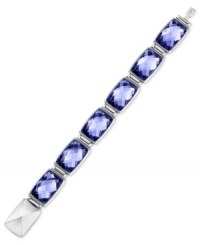 Discover bliss with Swarovski's Nirvana bracelet. It is crafted from rhodium-plated stainless steel with Tanzanite crystals inspiring tranquility. Approximate length: 8 inches.