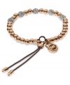 Add a little heat to your look. Michael Kors' stretchable bracelet combines rose-gold tone beads with pave crystal fireballs. Crafted in rose-gold tone mixed metal with an adjustable silk cord. Approximate diameter: 2-1/4 inches. Approximate width: 1/8 inch.