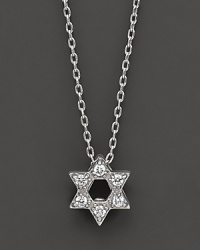 From the Tiny Treasures collection, a Star of David necklace makes a religious statement; with signature ruby accent. Designed by Roberto Coin.