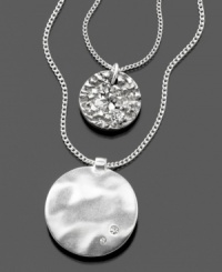 Emblematic style by Kenneth Cole New York. This beautiful two-strand pendant features crystal accents set in silvertone mixed metal. Approximate outer chain length: 18 inches + 3-1/2-inch extender. Approximate inner chain length: 16 inches. Approximate large pendant diameter: 1-3/4 inches. Approximate small pendant diameter: 1/2 inch.