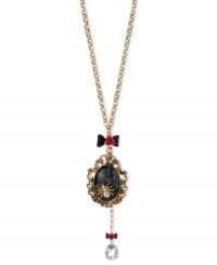 Enter Betsey Johnson's web of influence with this cameo and necklace, featuring a spider motif. Crafted from gold-tone mixed metal, the necklace features bow and flower details, a black oval locket and a teardrop glass crystal accent dangling down. Approximate length: 30 inches + 3-inch extender. Approximate drop (locket): 3-3/4 inches. Approximate drop (frontal chain): 5-1/4 inches.