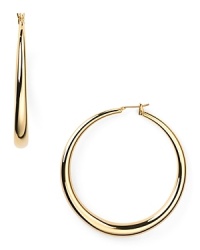 Timeless and poised, ABS by Allen Schwartz's gold hoop earrings are essential to any jewel box. The curvaceous baubles add versatile shine to staple tees or after hours ensembles.