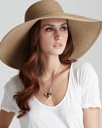 Stay on top of the trends this season in a large woven floppy hat with Eric Javits' signature logo rivet detail.