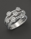 Seven sparkling diamonds, set in 18K. white gold, give the appearance of stacked rings. By Roberto Coin.