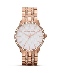 Michael Kors' mixes classic style with just-right glitz on this gorgeously-styled timepiece. Cast in rose gold and embellished with crystals and a Mother-of-Pearl face, it's one to watch.