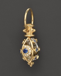 An 18K yellow gold evil eye amulet, set with diamonds and sapphires, frames a crystal. By Temple St. Clair.