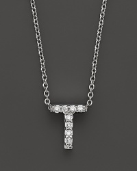 From the Tiny Treasures collection, a diamond T necklace. With signature ruby accent. Designed by Roberto Coin.