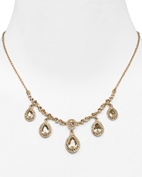 Dress up a simple look or go all out and sparkly with this gleaming drop necklace from Carolee. This piece features crystal-adorned teardrops for a notice-me neckline.