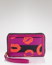 Sealed with a kiss, this MARC BY MARC JACOBS iPhone wristlet flaunts a puckered-up pattern with practical flair. Its leather wrist strap makes it perfect for travel.