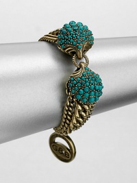 A Hellenic-inspired design that features a turquoise cabochon encrusted station and antique-finished brass link chains. TurquoiseAntique-finished brassLength, about 7.5Spring ring closureImported 