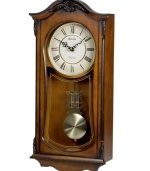 A mark of elegance. This stately wall clock by Bulova features a sturdy solid wood case with walnut finish accented by decorative carvings. White dial features Roman numerals and two hands; gold tone pendulum protected by glass lens. Plays Westminster melody on the hour.