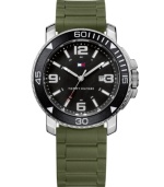 Let the adventure begin and bring this watch by Tommy Hilfiger along with you. Olive green silicone strap with faux link texture and round stainless steel case with white numerals at black bezel. Black dial features applied silver tone numerals at twelve, three, six and nine o'clock, stick indices, date window, three hands an iconic flag logo. Quartz movement. Water resistant to 30 meters. Ten-year limited warranty.