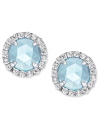 A mesmerizing accent piece, from CRISLU. These stud earrings feature a dome-cut center stone aquamarine (1-1/5 ct. t.w.) surrounded by micro-pave cubic zirconia accents. Earrings set in platinum over sterling silver. Approximate diameter: 1/3 inch.