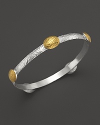 Domed yellow gold stations lend modern style to this hammered sterling silver bangle from Gurhan.