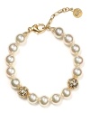 This Majorica pearl bracelet is decorated with sparkling gold-tone ball stations. For a special occasion, make this the finishing touch to accent your ensemble.