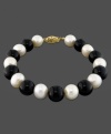 Always on trend. This gorgeous bracelet features cultured freshwater pearl (8-9 mm) and onyx (9 mm) set in 14k gold. Approximate length: 7-1/2 inches.