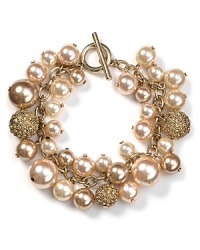 Always have something precious up your sleeve. With gleaming chains and crystal-adorned stations, this clustered bracelet from Carolee is a glamorous take on pearls.