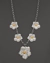 Delicate gardenias, captured at the height of their beauty in sterling silver and 18K yellow gold, bloom on this necklace from Buccellati.