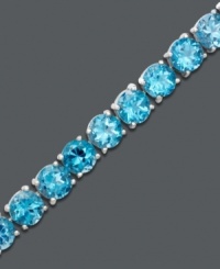 A tennis bracelet with a twist. Ocean-inspired round-cut blue topaz (20 ct. t.w.) shows your bright side. Bracelet crafted in sterling silver. Approximate length: 7 inches.