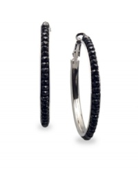 Looking for a little drama? Stir it up in these non-traditional hoop earrings from c.A.K.e. by Ali Khan. Crafted in hematite tone mixed metal, hoops feature jet black glass beads for edgy appeal. Approximate diameter: 1-5/8 inches.