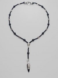 A strand of large and small black onyx beads, interspersed with textured sterling silver beads, with a Y-shaped drop, capped by a dramatic carved raven's head. Black onyx Sterling silver Length, about 15 Drop, about 4 Lobster clasp Imported