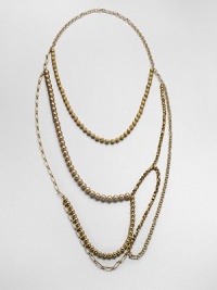 An artistic and modern design with faceted and smooth beads and various link chains in an abstract style. Glass and acrylic beadsGoldtone brassLength, about 47Slip-on styleImported 